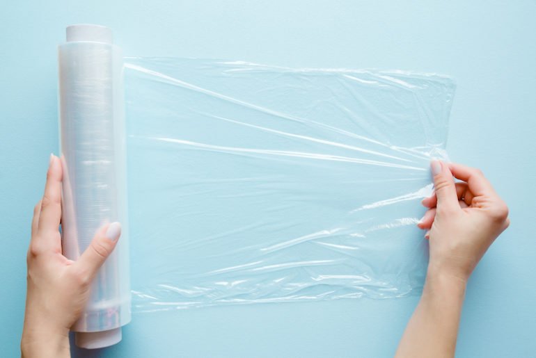 S’envelopper de film alimentaire : la nouvelle méthode pour maigrir ? Femme tenant un film alimentaire sur le ventre
